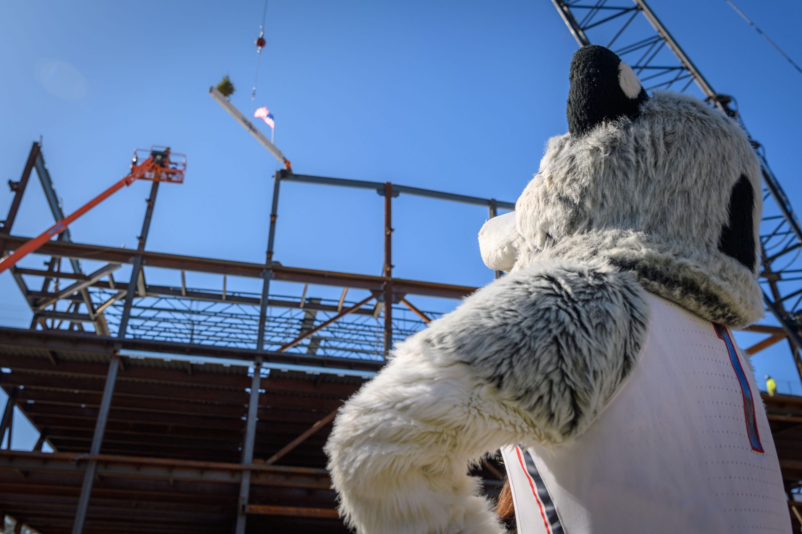 Jonathan the Husky looks on as the new student recreation facility is topped off on Feb. 27, 2018. (Peter Morenus/UConn Photo)